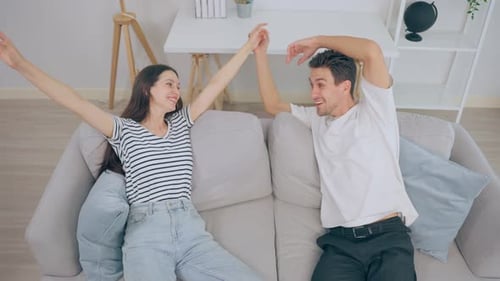 Happy Couple Lying on Couch at Home