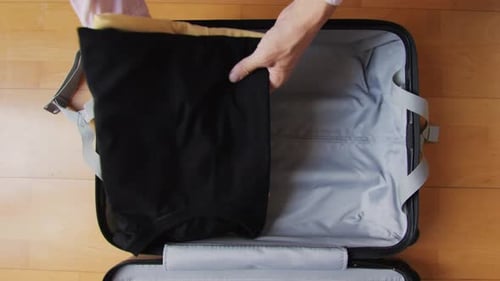 Packing a Black T-shirt in Suitcase