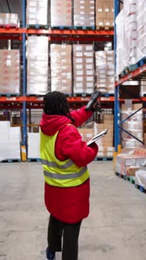 Warehouse Worker Managing Inventory in a Cold Storage Facility
