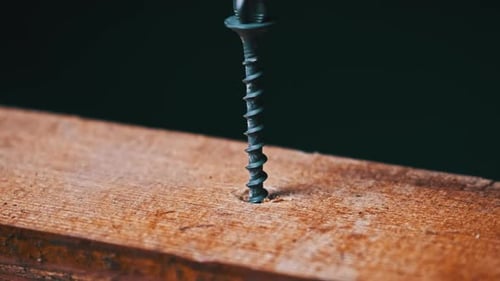 Screw Being Drilled into Wood Close Up
