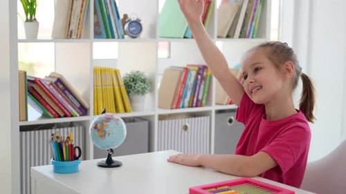 Girl Raises Hand in Bright Classroom Setting