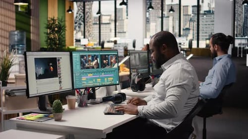 Video Editors Working at Computers in Modern Office