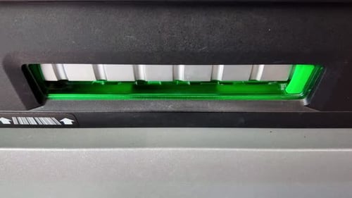 Close-up view about the ATM with banknote release, France.