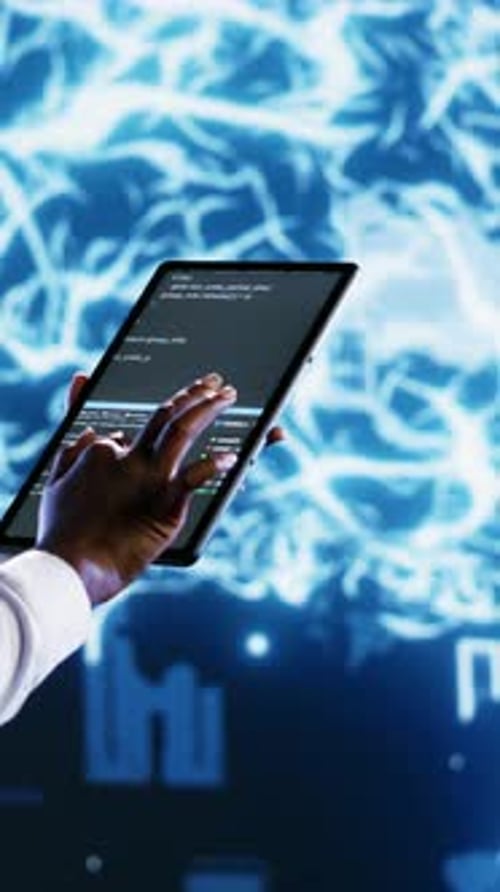 Hand Interacts with Tablet Displaying Code