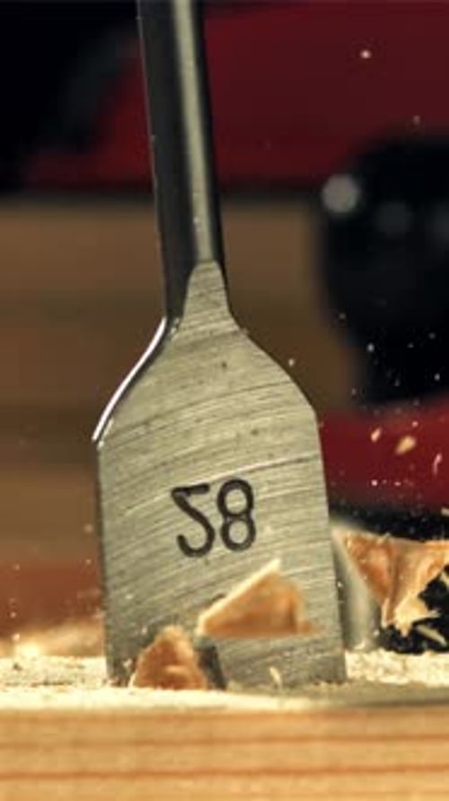 A Carpenter Drills a Hole in a Wooden Product Filmed on a Highspeed Camera at 1000 Fps