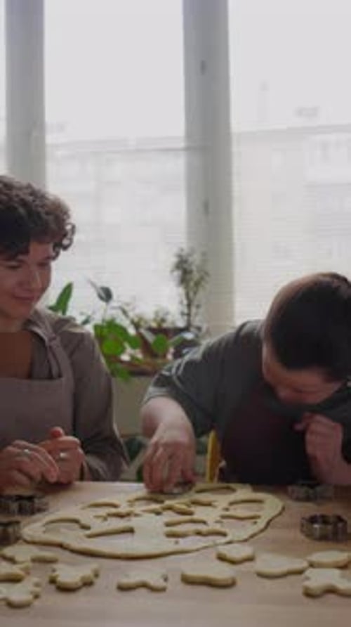 Two Friends Baking Cookies Together at Home