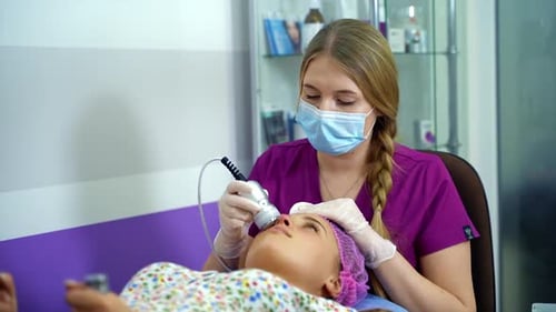 Beautiful woman with a beautician on the procedures. Spa procedures. Anti aging face skin treatment.