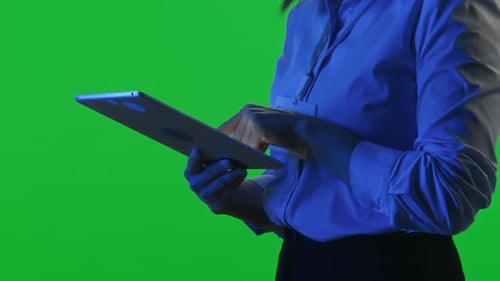 Close Up of Woman Using Digital Tablet against Chroma Key Wall