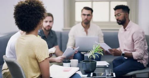 4k video footage of a group of young businesspeople having a meeting in a modern office