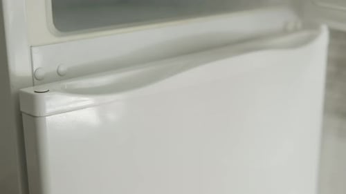 Hand of Person Opens Refrigerator Door and Stream of Cold Air Goes Down