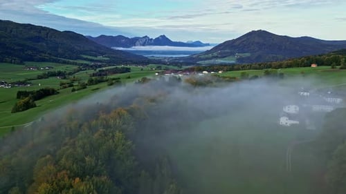Scenic Views with Layer of Fog Over the Landscape with Mountainous Background in a Green Lush Enviro