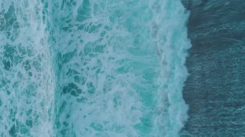 Huge stormy sea waves crashing on beach in evening dusk. Vertical video