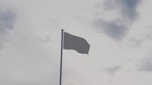 Waving Blank Flag Against Cloudy Sky