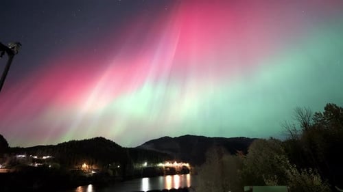 Vibrant Northern Lights Timelapse Over Fjord in Norway