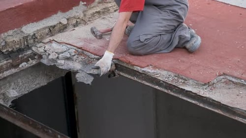 Unrecognizable man pulling the roof of a house down.