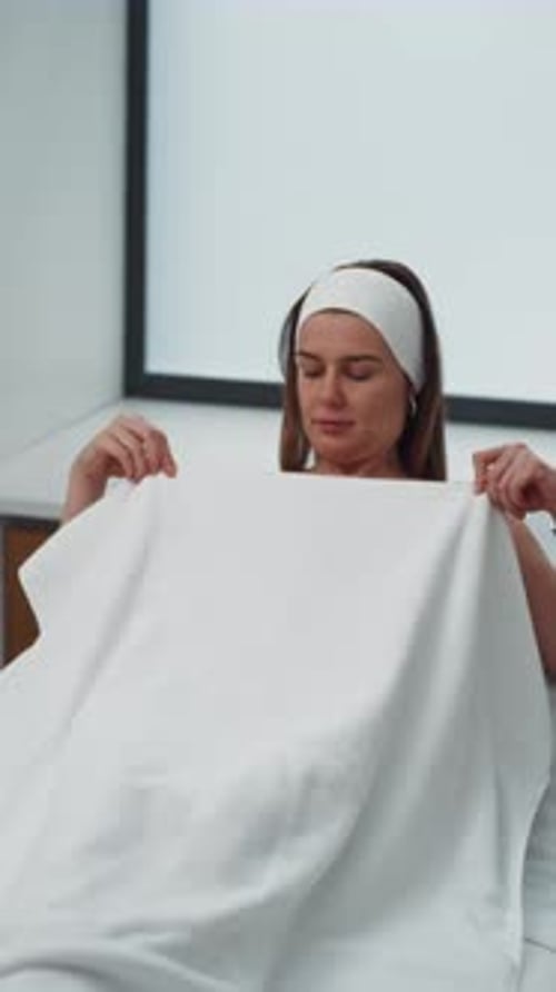 Woman Laying on Medical Examination Table with Towel