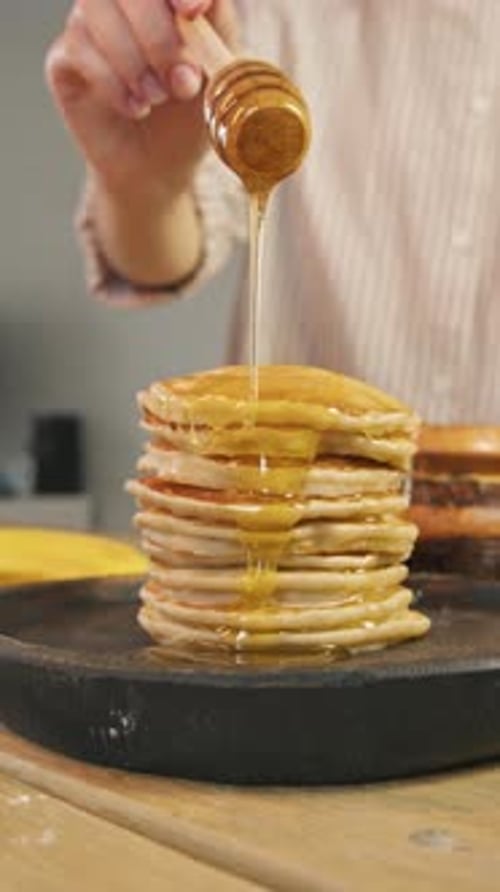 Honey Drizzled Over Pancakes on Wooden Surface