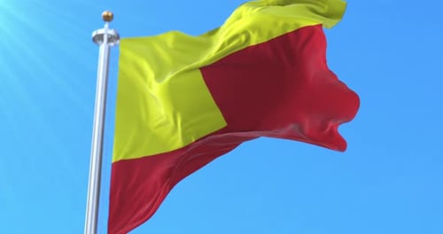 Karnataka State Flag Waving on Flagpole with Blue Sky