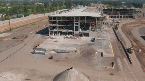 4k Aerial demolition site Drone dolly in + tilt up