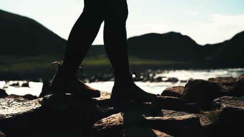 Silhouette of girls legs walking in front of ocean. Glorious slow motion.