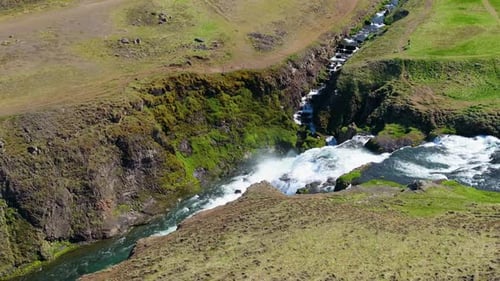 Aerial view of waterfall and river through canyon, Iceland.