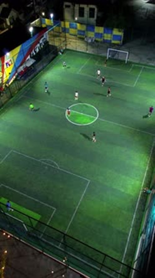 Vertical Drone Footage of mini football match, soccer. MiniFootball field and Footballers from drone