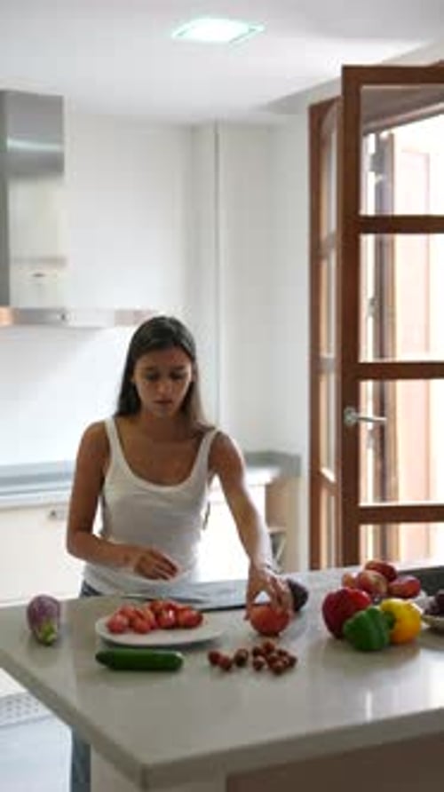 Woman Prepares Fresh Vegetables in Bright Kitchen