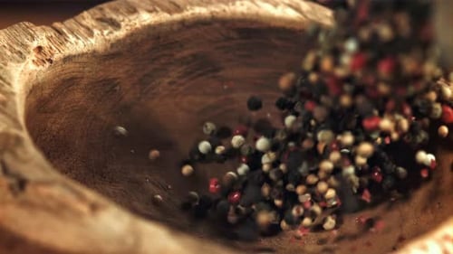 A Handful of Peppecorn Falls Into a Mortar Filmed on a Highspeed Camera at 1000 Fps