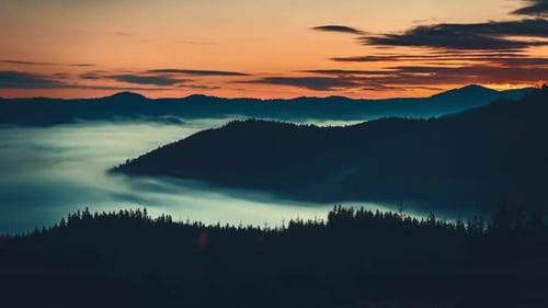 Sunrise Sea of Fog Moving Over Mountain Range