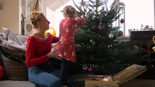 Mother and Child Decorating Christmas Tree Together
