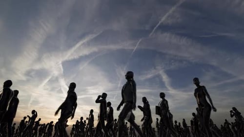 Animated Silhouetted Crowd Walking Under Dynamic Sky
