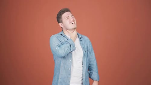 Man Coughing with a Sore Throat