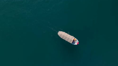 Boat Sailing Across the Turquoise Ocean