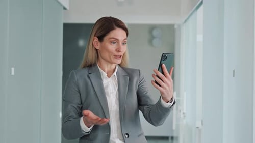 Woman in Suit Video Chatting in Office