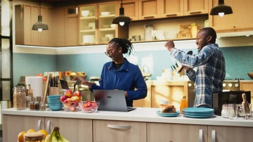 Happy Couple Singing with Kitchen Utensils at Home