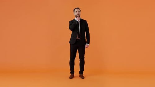 Bearded Pensive Guy in Formal Suit Holding Hand on Face Reasoning Over Problem