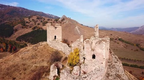 Forward drone shot over Coltesti medieval fortress, on a sunny autumn day