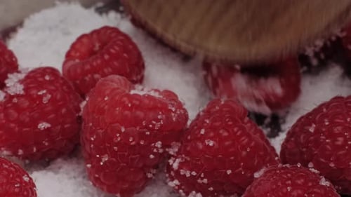 Fresh Raspberries Being Mixed with Sugar