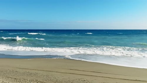 Waves Crashing on Sandy Beach Aerial View
