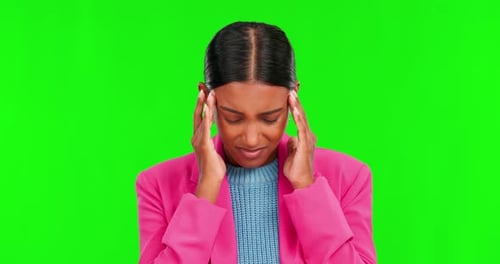 Headache, stress and pain with woman on green screen for anxiety, mental health and fatigue