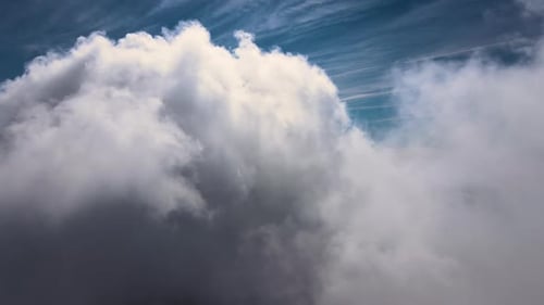 Aerial View From Airplane Window at High Altitude of Earth Covered with Puffy Cumulus Clouds Forming