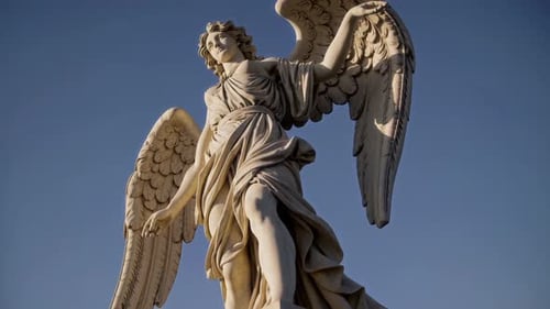 The Majestic Angel Statue Stands Tall Against a Clear and Beautiful Blue Sky Above