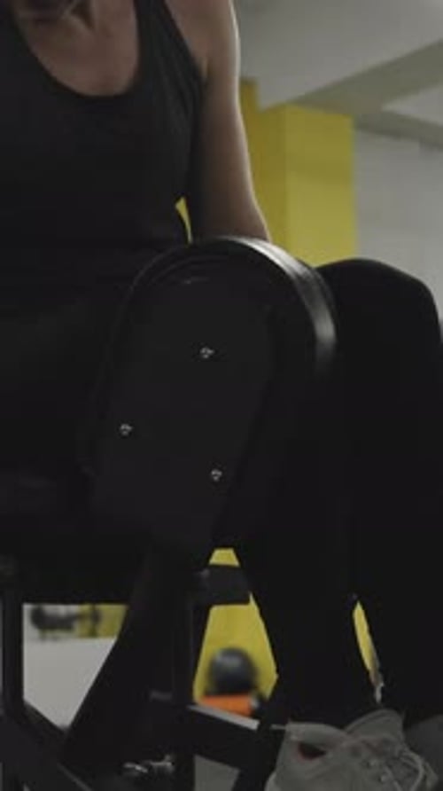 Woman on Leg Extension Machine at Gym