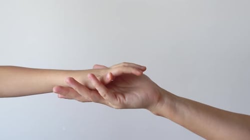Child Hand Gently Placed on Adult Open Palm