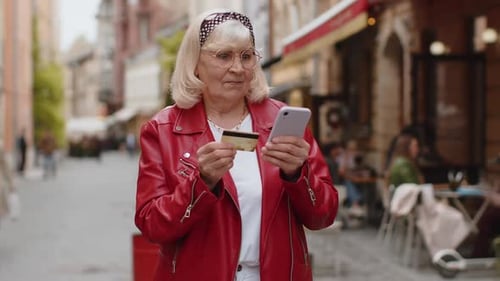 Senior Woman Using Credit Bank Card Smartphone While Transferring Money Purchases Online Shopping