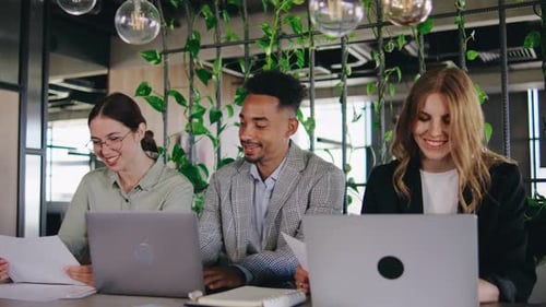 Collaborative Teamwork in a Modern Office Space A Diverse Group of Professionals Actively Engaging