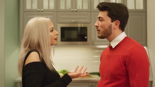 Loving Couple Talking and Kissing in Kitchen