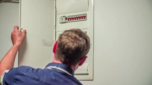 Man Opening and Closing a Fuse Box