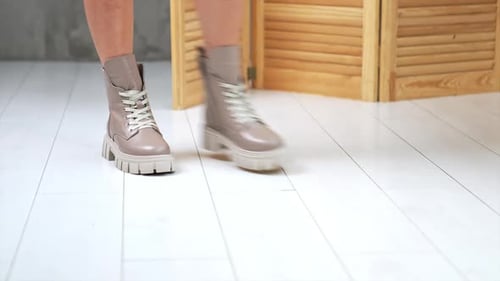 Woman Models Beige Boots With Laces Indoors