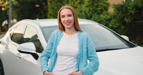 Smiling Woman Posing Next to Modern Car